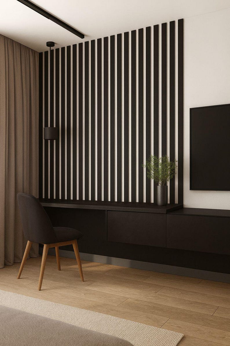 May include: Modern interior design featuring a black desk with drawers, a black chair, and a wall with vertical black and white stripes. A black television is mounted on the wall. The room has hardwood floors and a neutral-colored rug.