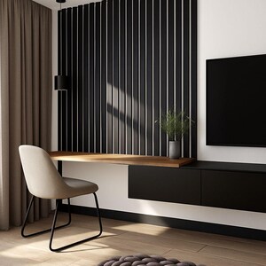 May include: A modern home office setup featuring a floating wooden desk, a beige chair with black legs, and a black storage unit. The wall has a vertical black and white striped design, with a small plant in a gray pot. A black TV is mounted on the wall.
