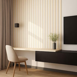 May include: Contemporary home office with a light wood desk and chair. The desk is integrated with a black storage unit and a vertical wood panel wall. A black pendant light hangs above the desk, and a vase with greenery sits on the desk.