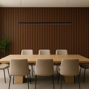 May include: A modern dining room featuring a large wooden table with eight beige chairs. The room has a dark brown slatted wall, a long black light fixture, and a large window. A small green plant is in the corner.