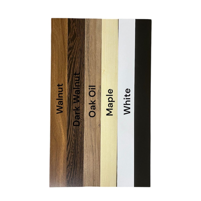 May include: A vertical display of wood samples labeled "Walnut," "Dark Walnut," "Oak Oil," "Maple," "White," and "Black." The samples showcase different wood grains and finishes, offering a variety of color options for home decor or craft projects.