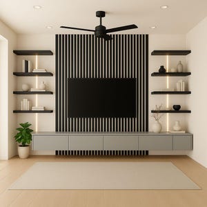 May include: Modern living room with a large black TV mounted on a wall with vertical black and white stripes. Gray cabinets and floating shelves with decor flank the TV. A ceiling fan and a neutral rug complete the space.
