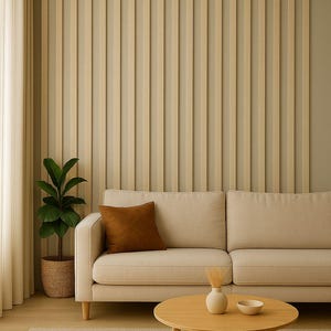 May include: A modern living room scene featuring a beige sofa with a brown throw pillow, a round wooden coffee table, and a potted plant. The wall has vertical wooden paneling, and the room is bathed in natural light.