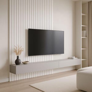 May include: A modern living room featuring a large, flat-screen television mounted on a white wall with vertical paneling. A gray floating media console holds decorative items. The room has a neutral color palette with a rug and a sectional.