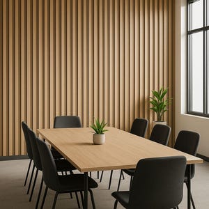 May include: A modern conference room with a light wood table and eight black chairs. The room features a light wood panel wall and a window with a black frame. Two potted plants are on the table and in the corner.