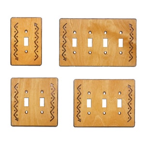 May include: Four wooden light switch covers with a decorative border. The covers are in various sizes, with one, two, and three switches.