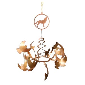 May include: A copper wind chime with a howling wolf silhouette on the top and multiple bird shapes on the bottom. The wind chime is suspended from a chain.
