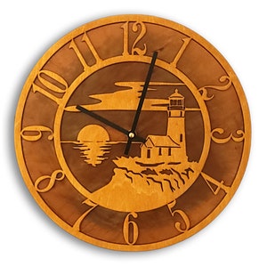 May include: A wooden clock with a lighthouse and sunset design. The clock face is brown with white numbers and black hands. The clock is 12 inches in diameter.