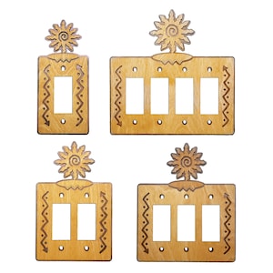 May include: Four wooden light switch covers with a Southwestern design. Each cover features a stylized sun with a swirl design and a decorative border. The covers are available in single and triple switch configurations.