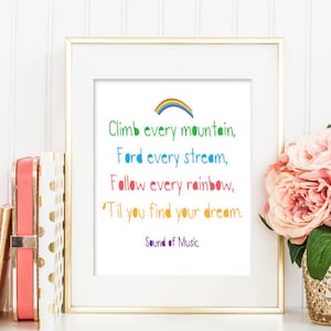 May include: A white framed print with a colorful rainbow and the text "Climb every mountain, Ford every stream, Follow every rainbow, 'Til you find your dream. Sound of Music"