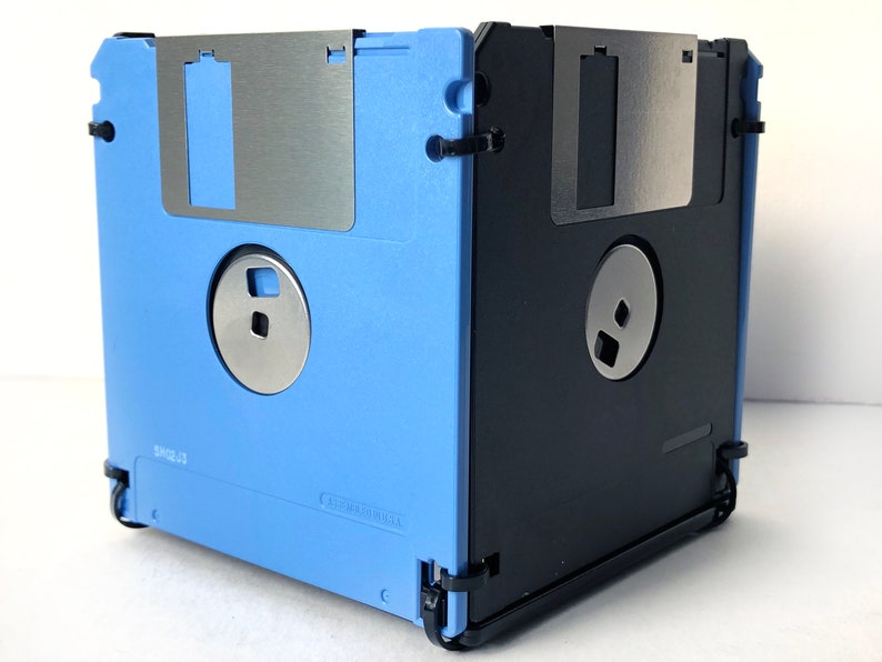 A diskette container shown in light blue and black with black cable tie fasteners.