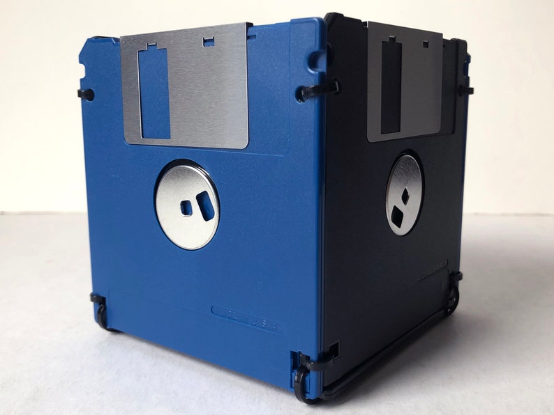 A diskette container shown in blue and black with black cable tie fasteners.