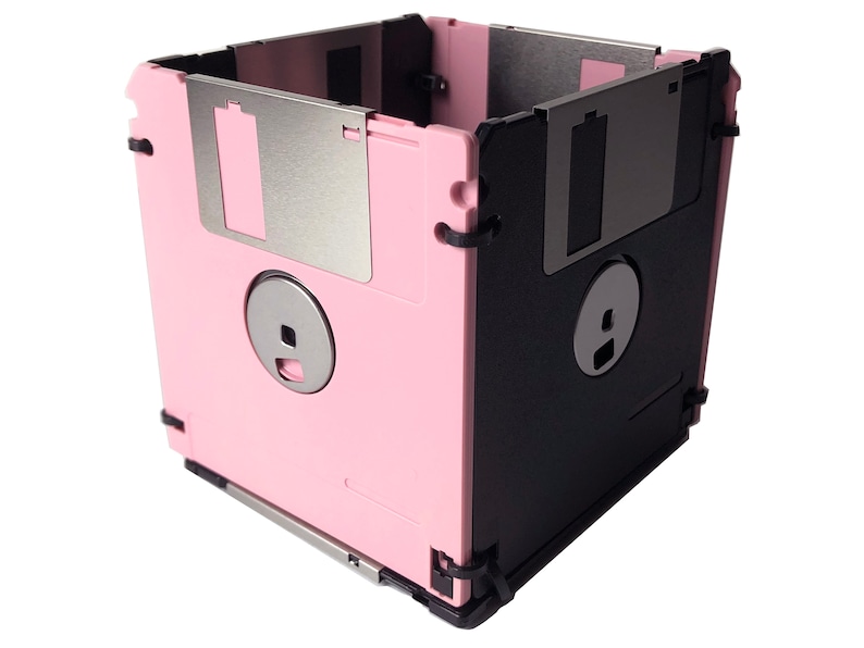 A diskette container shown in pink and black with black cable tie fasteners.