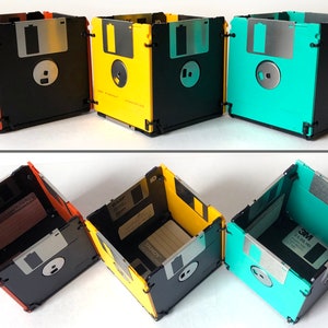 3 diskette containers shown in a split image. Horizontally across the top at eye level you see orange and black, yellow and black, and sea foam green and black. Across the bottom are the same boxes, but from an overhead view.