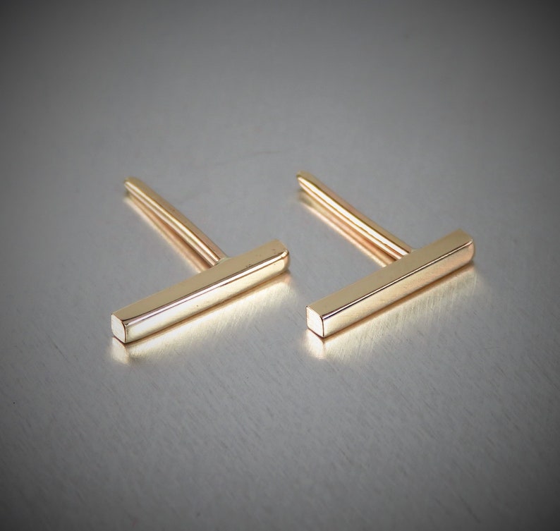 Handmade solid 14K yellow gold bar earrings. Made from square wire these bar earrings are 11mm long and 1.5mm by 1.5mm wide, looks like a long skinny rectangle. Also comes in Rose and White gold.