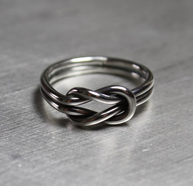 Handmade sterling silver sailor knot ring. Ring with a Celtic knot tied at the top in silver.