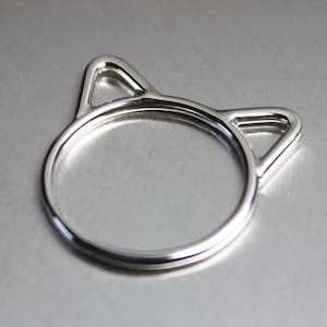 Handmade sterling silver cat ears ring. Wire design featuring a cat head silhouette with pointy ears.