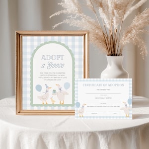 May include: A blue and green adoption certificate for a goose with a blue gingham background. The text reads "Adopt a Goose" and "Certificate of Adoption".