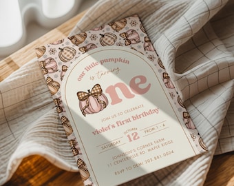 May include: A first birthday invitation with a pumpkin theme. The invitation features a pink pumpkin with a bow, the text "one", and the words "our little pumpkin is turning". The invitation is decorated with pumpkins and flowers.