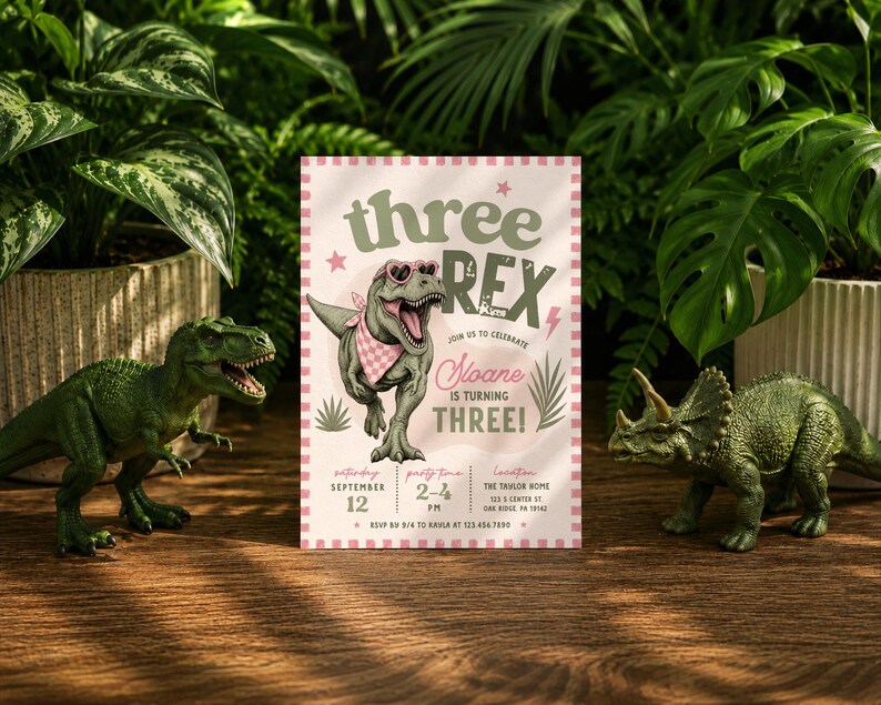 May include: A rectangular birthday invitation card featuring a green T-Rex wearing pink heart-shaped sunglasses and a pink checkered bandana. The text reads: three REX, join us to celebrate Sloane is turning THREE, Saturday September 12, 2-4 PM, The Taylor Home.