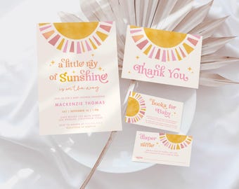 May include: A set of baby shower invitations with a sun design in pink, yellow, and orange. The text on the invitations reads "a little ray of sunshine is on the way", "Mackenzie Thomas", "Sat 1 September 10 AM", "Cake, Gifts, and Fun", "RSVP to Marie at 555-1212", "Thank You", "Books for Baby", and "Diaper Raffle".