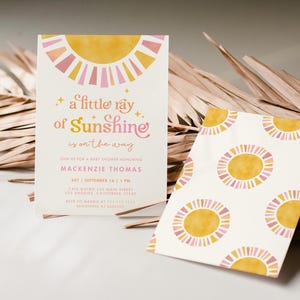 May include: A baby shower invitation with a yellow sun graphic and the text "a little ray of Sunshine is on the way". The invitation is for Mackenzie Thomas and is set for September 14th at 1 p.m.
