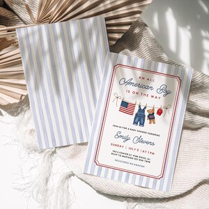 May include: Baby shower invitation with blue and white striped background. The invitation reads "An All American Boy is on the Way." The invitation includes an American flag, overalls, a teddy bear, and a baseball cap.