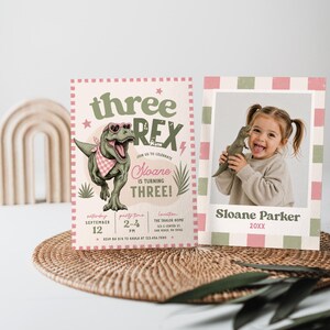 May include: A birthday invitation set featuring a cream-colored card with a green T-Rex wearing pink heart sunglasses and a checkered bandana, with text reading Three Rex, Sloane is turning three, and a photo card with a child holding a toy dinosaur.