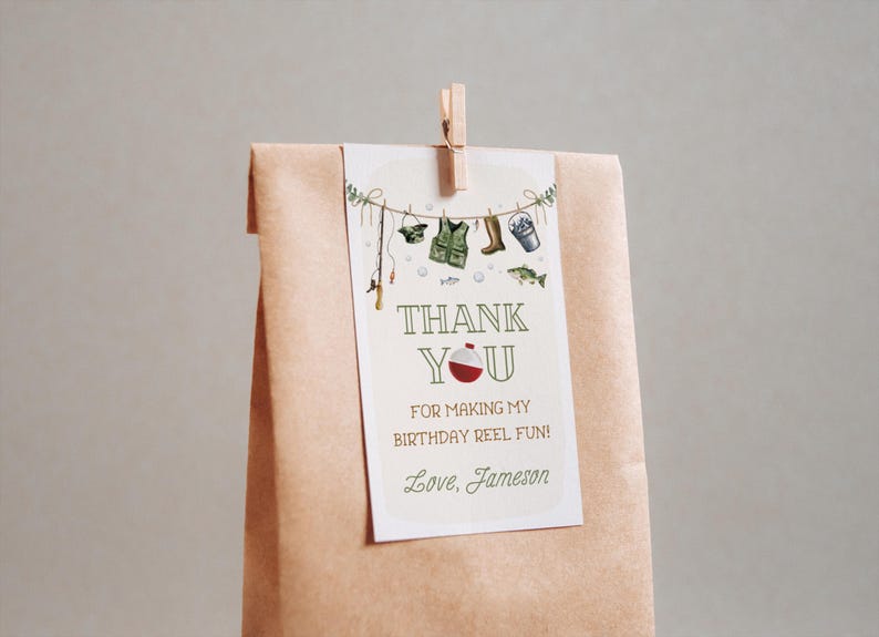 May include: A white thank you card with a fishing theme. The card has a red and white fishing bobber, a fishing rod, a life vest, boots, and a bucket with fishing lures. The text on the card reads "Thank You for making my birthday reel fun! Love, Jameson".