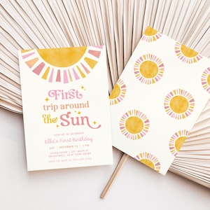 May include: Two invitations with a sun theme. One invitation has the text "First trip around the Sun" with event details. The other invitation has a repeating sun pattern. The suns are yellow and pink on a white background.
