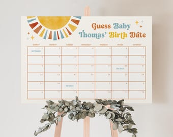 May include: A printable calendar with a sunburst design in yellow, orange, and blue. The calendar is for guessing the birth date of a baby named Thomas. The due date is marked on the calendar.