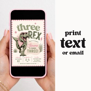 May include: A digital invitation displayed on a smartphone screen featuring a green T-Rex wearing heart-shaped sunglasses and a pink checkered bandana. The text reads: three REX, Sloane IS TURNING THREE, and event details. The words print text or email appear.
