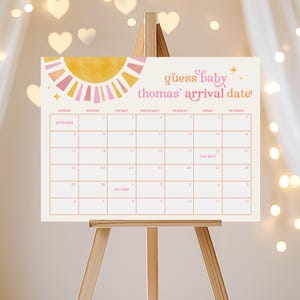 May include: A pink and yellow sun graphic with a calendar for September and October. The calendar has the text "guess baby thomas' arrival date" at the top.