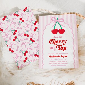 May include: Baby shower invitations with a cherry theme. One card features the text "she's the Cherry on Top" with red cherries and a pink bow. The other card has a pattern of cherries and pink bows on a white background.
