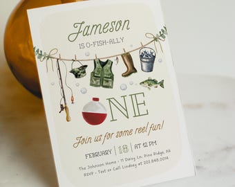 Può includere: Un invito al primo compleanno a tema pesca per un bambino di nome Jameson. L'invito presenta un galleggiante da pesca verde, bianco e rosso, una canna da pesca, un giubbotto da pesca e un secchio di pesce. Il testo recita "Jameson is O-Fish-Ally One. Unisciti a noi per un po' di divertimento reale! Febbraio 18 alle 12:00. The Johnson Home 11 Daisy Ln. Pine Ridge, PA. RSVP Testo o chiamata a Lindsey al 202.848.0014."