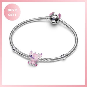 A silver bracelet with a charm featuring a pink elephant and a silver Stitch character.