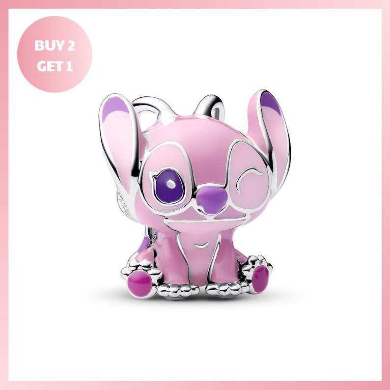 A pink and silver Stitch charm in the shape of a cartoon character, with a purple nose and eyes, sitting on its hind legs.