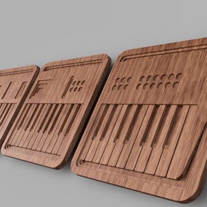 May include: Three wooden wall decor pieces shaped like vintage synthesizers with a wood grain finish. Each piece features a keyboard, knobs, and buttons.
