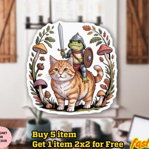 May include: A whimsical sticker featuring an orange tabby cat with a frog knight riding on its back, holding a sword and shield. The design is surrounded by mushrooms and foliage. The sticker is waterproof and can be used as a magnet.