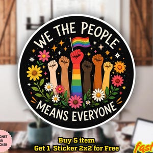 May include: A round sticker with the text "WE THE PEOPLE MEANS EVERYONE" in white. The design features raised fists in various skin tones, a rainbow flag, flowers, and stars on a black background. The sticker is waterproof and can be used as a magnet.