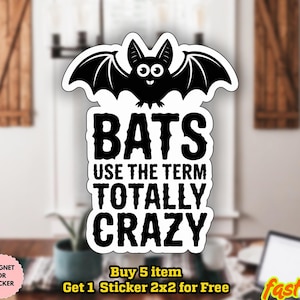 May include: A white ceramic mug with a black handle and the text "But First, Coffee" in a black, bold font. The mug is on a white surface.