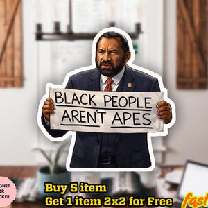 May include: A sticker featuring a man in a suit holding a sign that reads "BLACK PEOPLE AREN'T APES". The sticker has a white border and is set against a blurred background.