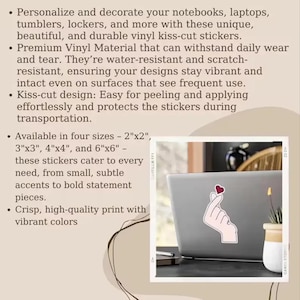 May include: A laptop with a sticker of a hand making a heart shape. The sticker is white with a red heart. The image also includes text about vinyl kiss-cut stickers available in four sizes.