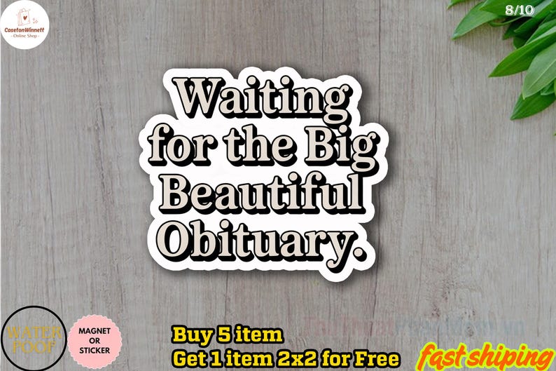 May include: A white sticker with black text that reads "Waiting for the Big Beautiful Obituary." The sticker has a black border and is on a light wood-grain surface. The sticker is a magnet or sticker.