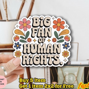 May include: A sticker with the text "BIG FAN OF HUMAN RIGHTS" in a retro font, surrounded by colorful flowers and leaves. The sticker is held by a hand. The sticker is water-resistant.