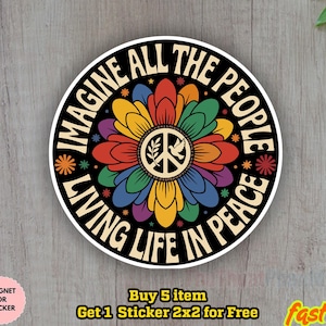 May include: A circular sticker with the words "IMAGINE ALL THE PEOPLE LIVING LIFE IN PEACE". The design includes a vibrant flower with a peace symbol at its core. The sticker has a black background and a white border.