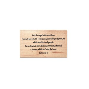 May include: A wooden stamp with the text "And the angel said unto them, Fear not: for, behold, I bring you good tidings of great joy, which shall be to all people. For unto you is born this day in the city of David a Saviour, which is Christ the Lord. Luke 2:10-11"
