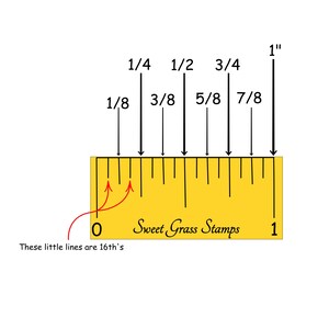 May include: A yellow ruler with black markings showing increments of 1/8 inch, 1/4 inch, 1/2 inch, 3/4 inch, and 1 inch. The ruler also has smaller markings for 1/16 inch increments. The text "Sweet Grass Stamps" is printed on the ruler.