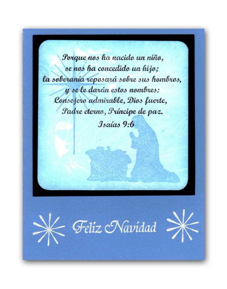 May include: A blue Christmas card with a white snowflake design and the text "Feliz Navidad". The card features a silhouette of the nativity scene with the text "Porque nos ha nacido un ni&ntilde;o, se nos ha concedido un hijo; la soberan&iacute;a reposar&aacute; sobre sus hombros, y se le dar&aacute;n estos nombres: Consejero admirable, Dios fuerte, Padre eterno, Pr&iacute;ncipe de paz. Isa&iacute;as 9:6"