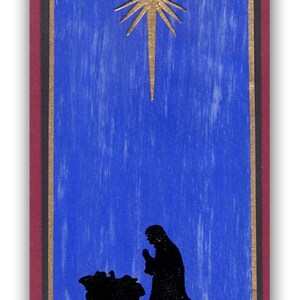 Op de afbeelding: Een blauwe en gouden kerstkaart met een ster en een silhouet van de kerststal. De kaart heeft de tekst "Joyeux No&euml;l".